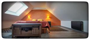 a attic bedroom with a bed and a skylight at Luna in Plouha