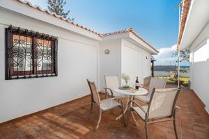 een kamer met een tafel en stoelen op een patio bij Villa del Mar Palm Mar in Palm-mar