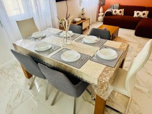 a dining room table with plates on top of it at Appartement Premium 4 Stars - Trigone in Montpellier