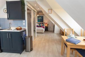 a kitchen and dining room with a staircase in a house at The Loft at Tanglewood in Wrington