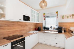 a kitchen with white cabinets and a wooden counter top at Ferienhaus Purgar in Kammern im Liesingtal