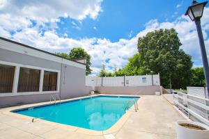 a swimming pool in the backyard of a house at Americas Best Value Inn Winston-Salem in Winston-Salem