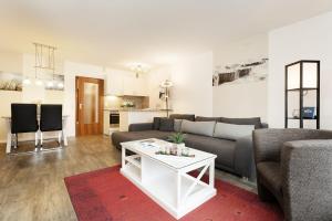 a living room with a couch and a table at Waldstraße 4 Waldkoje in Kellenhusen