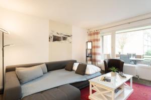 a living room with a couch and a table at Waldstraße 4 Waldkoje in Kellenhusen +40 photos