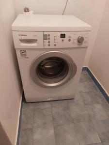 a washing machine sitting in a corner of a room at Apartment Milano in Matulji