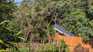 a wooden fence with trees in the background at Barangata collections in Barangata