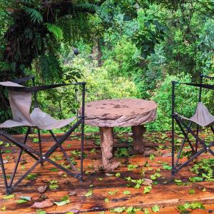 a table and two chairs sitting next to a table at Barangata collections in Barangata