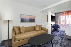 a living room with a couch and a table at Fairfield Inn and Suites by Marriott San Jose Airport in San Jose