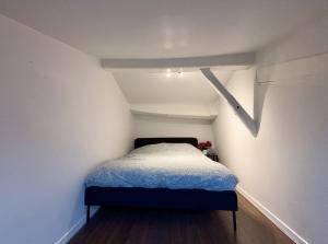a small room with a small bed in a attic at Charmant duplex in Clermont-Ferrand +10 photos