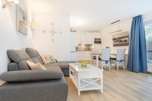 a living room with a couch and a table at Wohnung 113 in Timmendorfer Strand