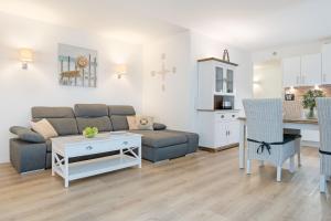 a living room with a couch and a table at Wohnung 113 in Timmendorfer Strand