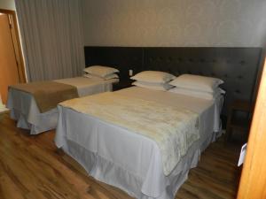 En eller flere senge i et værelse på Splendore Hotel