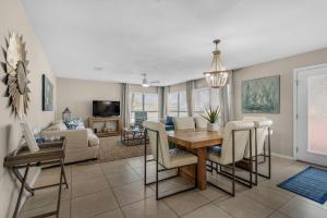 a dining room and living room with a table and chairs at Beach on a Budget by Gulf Coast Getaways in Navarre