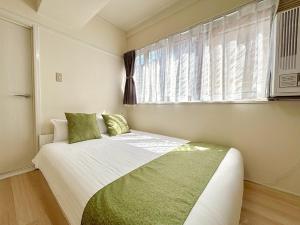 Postel nebo postele na pokoji v ubytování Neighbor's Hotel 十日市