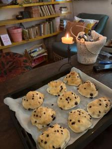 a tray of cookies on a table with a candle at Penelope B&B in Palermo