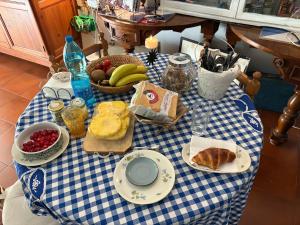 a table with a blue and white checkered table cloth at Penelope B&B in Palermo