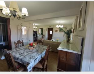 a kitchen and dining room with a table and chairs at El Resbalón in Comillas