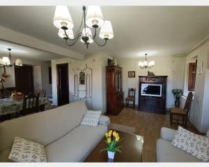 a living room with a couch and a dining room at El Resbalón in Comillas