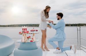 a man and a woman standing on a boat at Dom na Zalewie in Wieniawa