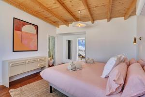 a bedroom with a large bed and a wooden ceiling at Penthouse in El Cotillo in Cotillo