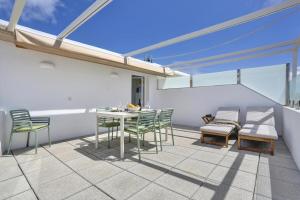 a patio with a table and chairs on a balcony at Penthouse in El Cotillo in Cotillo