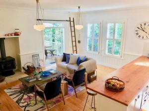 a living room with a couch and a table at Mirrabella Blue Mountains Boutique Getaway in Blackheath