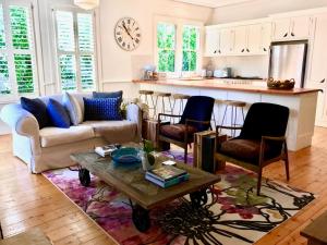 a living room with a couch and a table at Mirrabella Blue Mountains Boutique Getaway in Blackheath