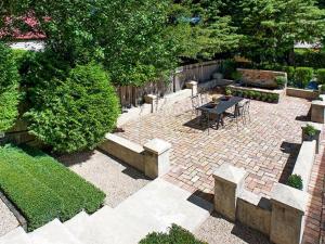 a garden with a brick patio with a table and benches at Mirrabella Blue Mountains Boutique Getaway in Blackheath +13 photos