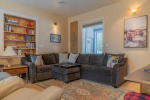 a living room with a couch and a table at The Chena Hills Chill And Hot Soak in Fairbanks