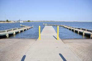 a dock with yellow poles in the water at 3BR Quiet Cottage Private Dock Fishing in Davis