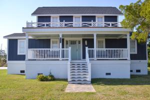 a large white house with a porch and balcony at 4BR Historic Home Private Dock Fishing in Davis