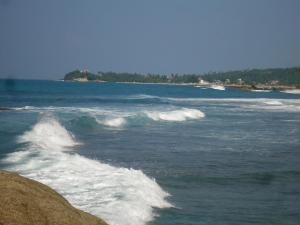 a wave in the ocean on a beach at Disa Residence in Galle