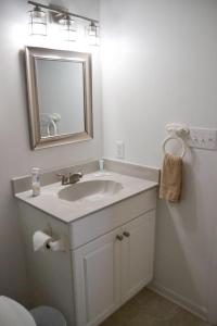 a bathroom with a sink and a mirror at 3BR Loft Cozy House Fishing Boating Views in Sealevel