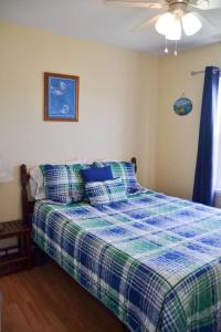 a bedroom with a bed and a ceiling fan at 3BR Loft Cozy House Fishing Boating Views in Sealevel