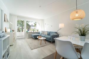 a living room with a blue couch and a table at Strandschloss Wohnung 40 in Grömitz