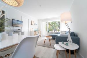 a living room with a table and a blue couch at Strandschloss Wohnung 40 in Grömitz