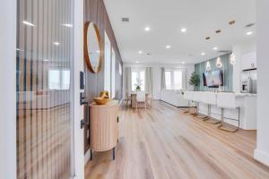 a lobby with a waiting room with tables and a mirror at Classy 4BD 3.5BA with Soak Tub Backyard and Game Room in Houston