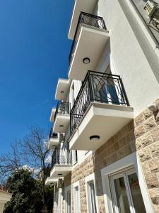 a white building with balconies on the side of it at Casa M- Studio #1 - Brand New in Herceg-Novi +7 photos