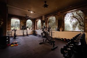 a gym with treadmills and exercise equipment in a room at Olinto, Atlas Mountain Retreat - adults only in Ouirgane