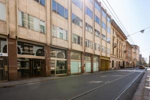 an empty street in front of a building at Arsenale Turin Rooms in Turin
