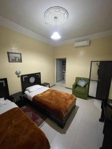Postel nebo postele na pokoji v ubytování Hôtel Narjisse