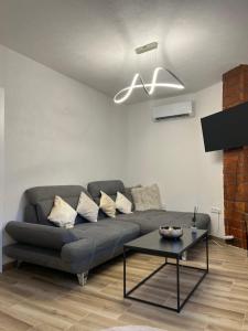 a living room with a couch and a table at Guest House Eden in Bihać