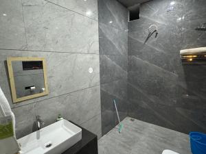 a bathroom with a sink and a shower at Comfort stay in Beās
