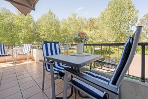 a table and two chairs on a balcony at Haus Baltic Ostseeidylle in Scharbeutz