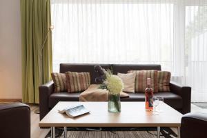 a living room with a couch and a table at Haus Baltic Ostseeidylle in Scharbeutz