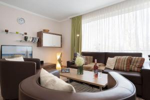 a living room with a couch and a table at Haus Baltic Ostseeidylle in Scharbeutz