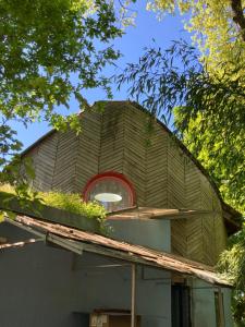 a house with a roof with a window on top at COUETTE et CAFÉ L'AGENCE in Boutigny-sur-Essonnes