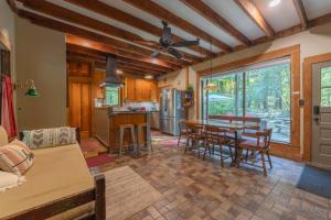 a kitchen and living room with a table and chairs at Walking distance to Lake Michigan! Cozy Cottage in Fennville