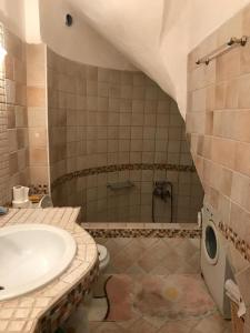 a bathroom with a sink and a toilet and a tub at Villa Blue Lagoon in Afitos