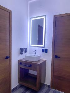 a bathroom with a white sink and a mirror at Casa Love Us in Tequisquiapan +25 photos